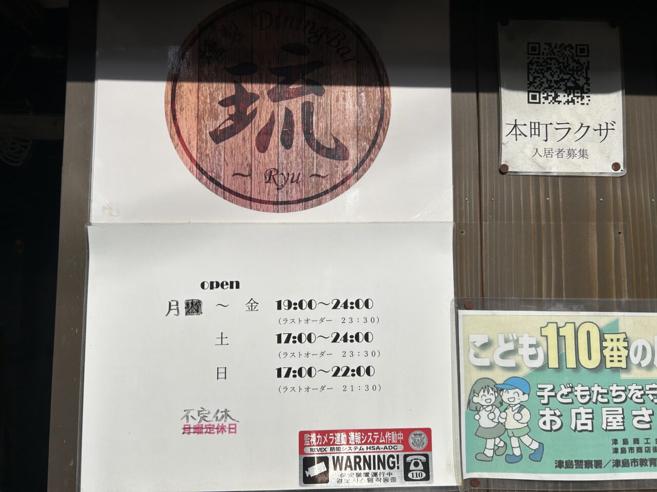 燻製ダイニングバー琉の入口に掲示された営業時間のお知らせポスター