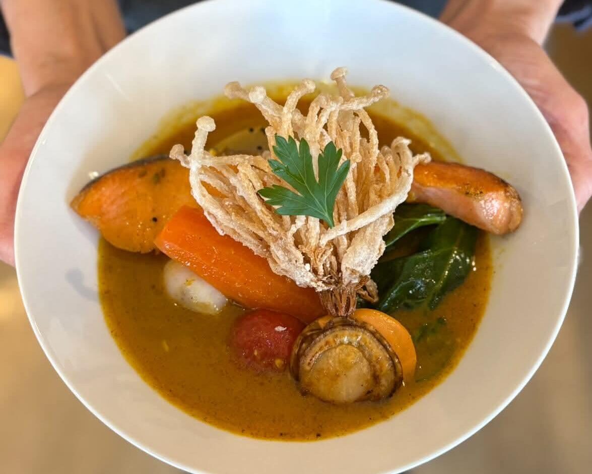 旬の鮮魚や出汁で炊いた野菜が盛り付けられた食堂αのスープカレー